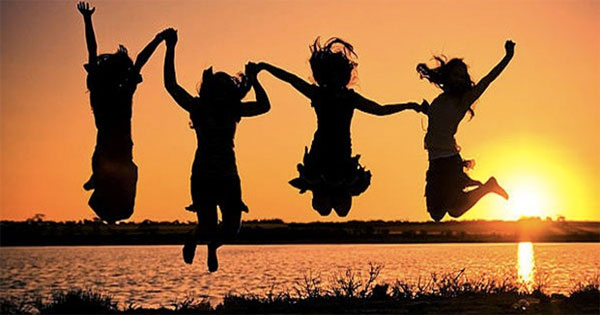 Smiling woman radiating joy and happiness in warm golden light
