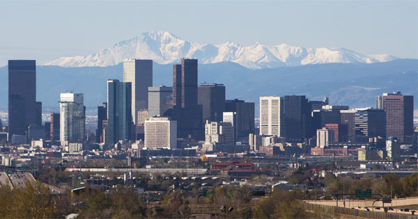 Smiling person enjoying Denver Colorado mountains city skyline outdoors